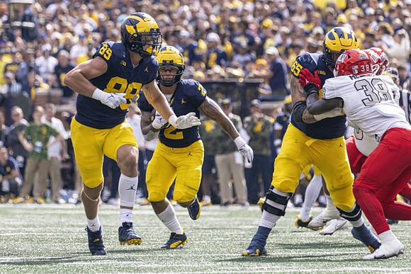 AJ Barner (89), Blake Corum (2), and Zak Zinter (65)