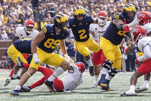 AJ Barner (89), Blake Corum (2), and Zak Zinter (65)
