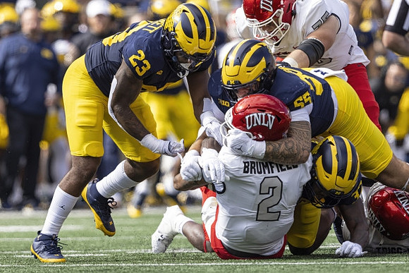 Michael Barrett (23), Mason Graham (55), and Jaylen Harrell (32)