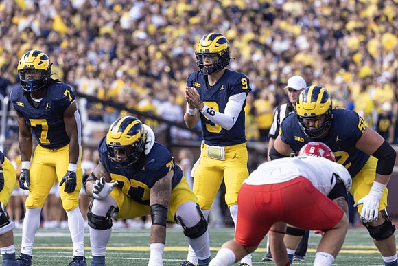 Donovan Edwards (7), Trevor Keegan (77), J.J. McCarthy (9), and Karsen Barnhart (52)