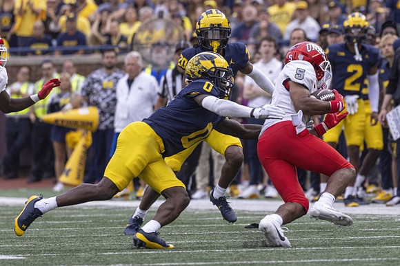 Jyaire Hill (20) and Mike Sainristil (0)