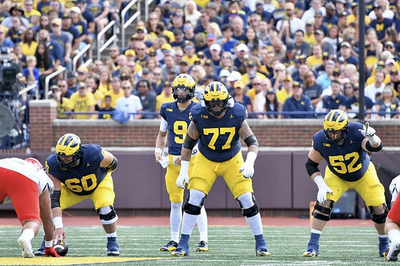 Drake Nugent (60), J.J. McCarthy (9), Trevor Keegan (77), and Karsen Barnhart (52)