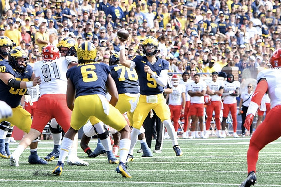 Drake Nugent (60), Cornelius Johnson (6), Myles Hinton (78), and J.J. McCarthy (9)