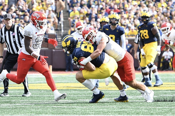 AJ Barner (89), J.J. McCarthy (9), and Myles Hinton (78)