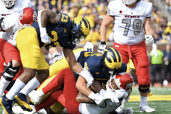Michael Barrett (23), Mason Graham (55), and Jaylen Harrell (32)