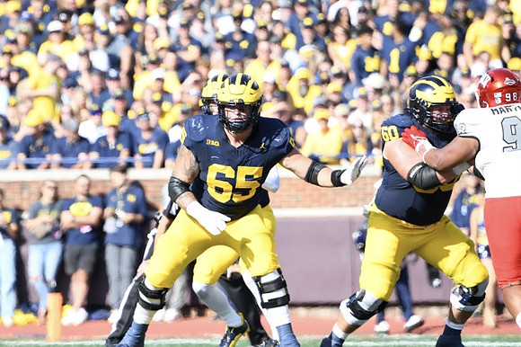 Zak Zinter (65), J.J. McCarthy (9), and Drake Nugent (60)