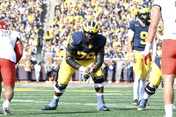 Myles Hinton (78) and J.J. McCarthy (9)