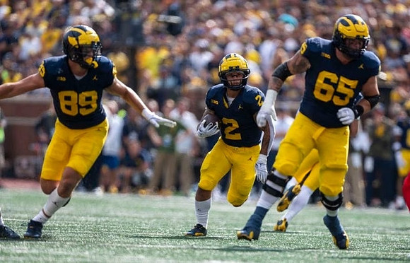 AJ Barner (89), Blake Corum (2), and Zak Zinter (65)