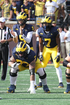 J.J. McCarthy (9), Trevor Keegan (77), and Donovan Edwards (7)