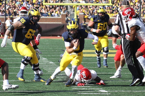 Zak Zinter (65), J.J. McCarthy (9), and Drake Nugent (60)
