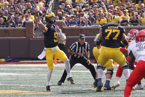 J.J. McCarthy (9) and Trevor Keegan (77)