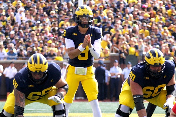 Zak Zinter (65), J.J. McCarthy (9), and Drake Nugent (60)