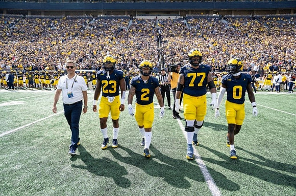 Michael Barrett (23), Blake Corum (2), Trevor Keegan (77), and Mike Sainristil (0)