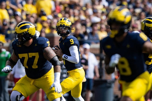 Trevor Keegan (77), J.J. McCarthy (9), and Tyler Morris (8)