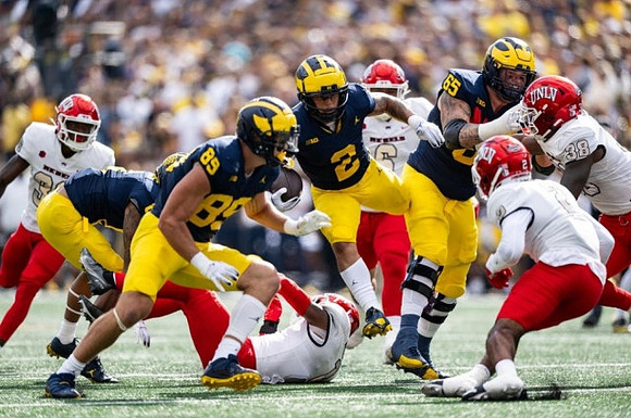 AJ Barner (89), Blake Corum (2), and Zak Zinter (65)