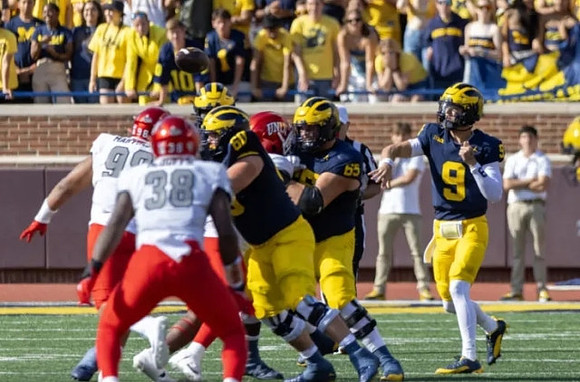Drake Nugent (60), Zak Zinter (65), and J.J. McCarthy (9)