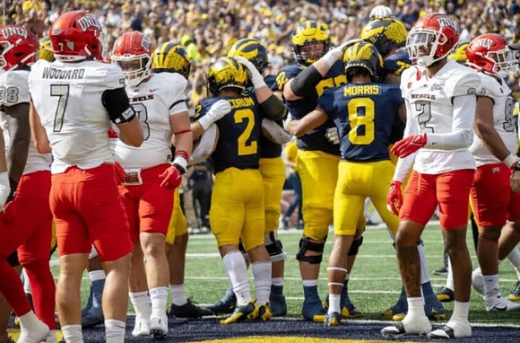 Blake Corum (2), Karsen Barnhart (52), Tyler Morris (8), and Trevor Keegan (77)