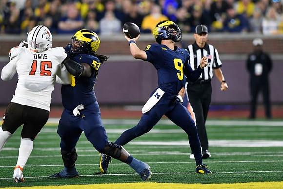 Trente Jones (53) and J.J. McCarthy (9)