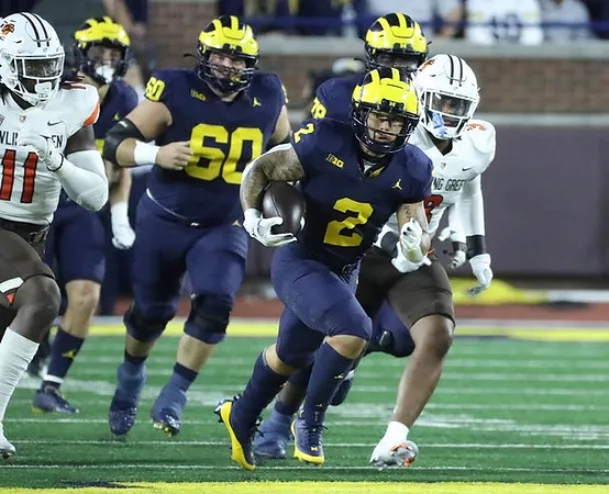 Drake Nugent (60), Blake Corum (2), and Myles Hinton (78)