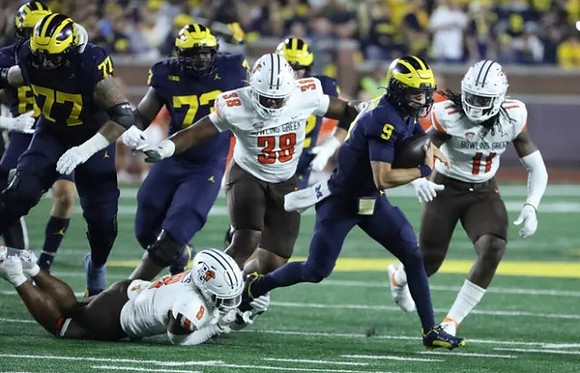 Trevor Keegan (77), LaDarius Henderson (73), and J.J. McCarthy (9)