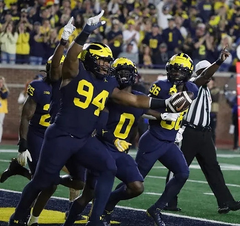 Kris Jenkins (94), Junior Colson (25), Mike Sainristil (0), and Keshaun Harris (36)