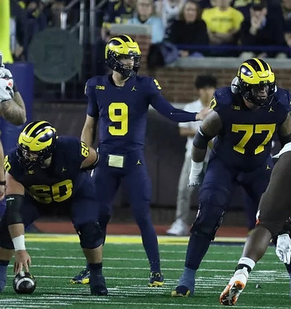 Drake Nugent (60), J.J. McCarthy (9), and Trevor Keegan (77)