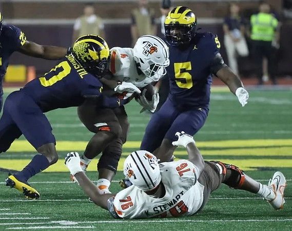 Mike Sainristil (0) and Josaiah Stewart (5)