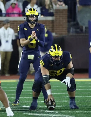 J.J. McCarthy (9) and Drake Nugent (60)