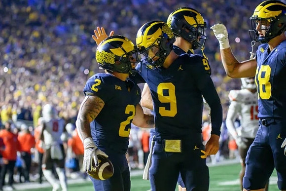 Blake Corum (2), J.J. McCarthy (9), and Colston Loveland (18)