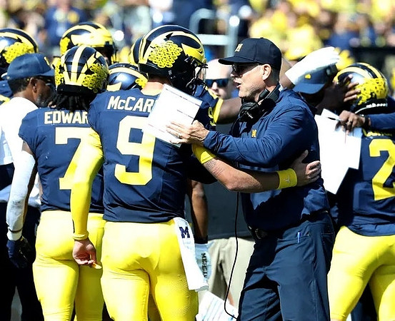 Donovan Edwards (7), J.J. McCarthy (9), and Jim Harbaugh