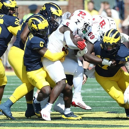 Rayshaun Benny (26), Mike Sainristil (0), and Braiden McGregor (17)