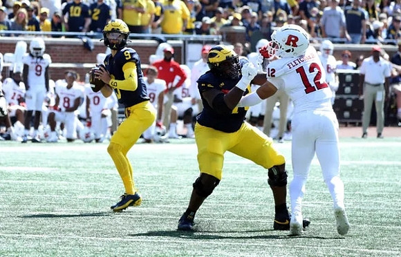 J.J. McCarthy (9) and Myles Hinton (78)