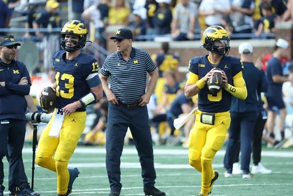 Kendrick Bell (12), Jim Harbaugh, and J.J. McCarthy (9)