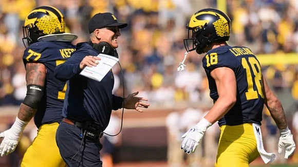 Trevor Keegan (77), Jim Harbaugh, and Colston Loveland (18)
