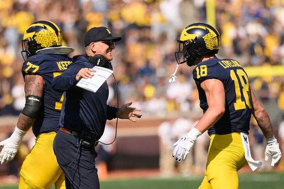 Trevor Keegan (77), Jim Harbaugh, and Colston Loveland (18)
