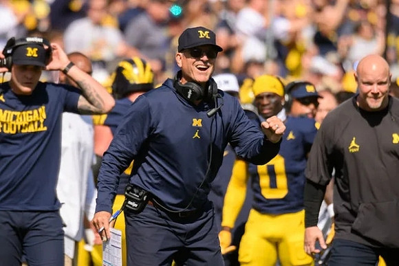 Jim Harbaugh, Mike Sainristil (0), and Ben Herbert