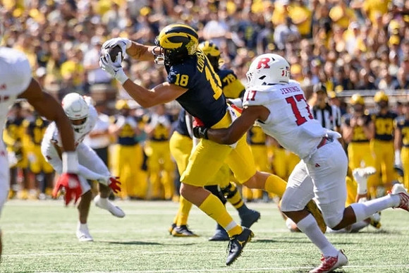Colston Loveland (18) and Myles Hinton (78)
