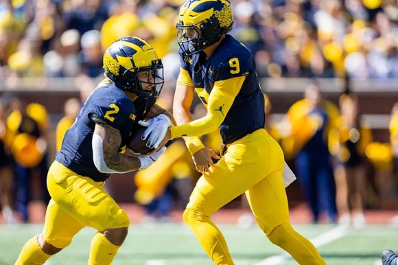 Blake Corum (2) and J.J. McCarthy (9)