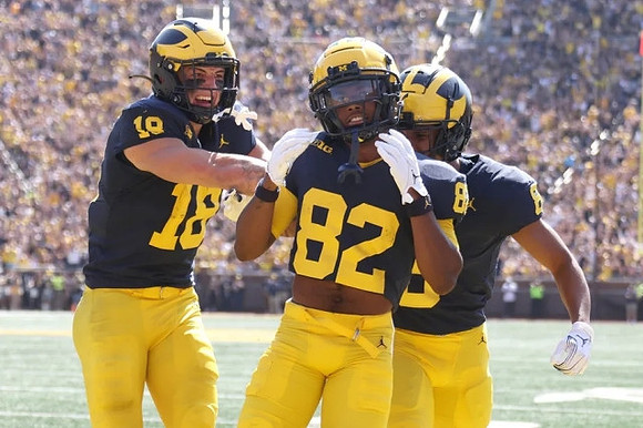 Colston Loveland (18), Semaj Morgan (82), and Tyler Morris (8)