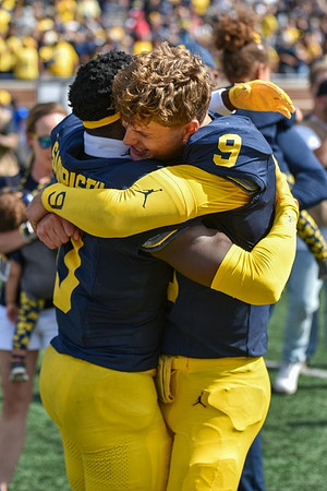 Mike Sainristil (0) and J.J. McCarthy (9)