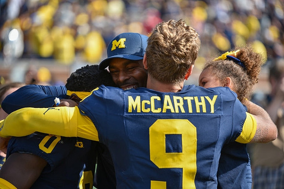 Mike Sainristil (0), Sherrone Moore, and J.J. McCarthy (9)