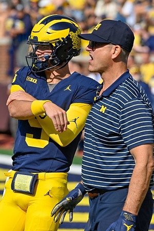 J.J. McCarthy (9) and Jim Harbaugh