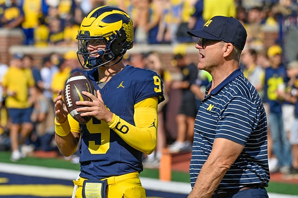 J.J. McCarthy (9) and Jim Harbaugh