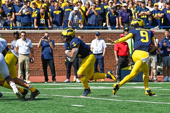 Blake Corum (2) and J.J. McCarthy (9)