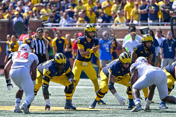 Myles Hinton (78), J.J. McCarthy (9), Zak Zinter (65), and Blake Corum (2)