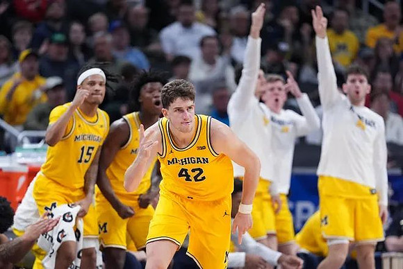 Will Tschetter (42) and Michigan Team