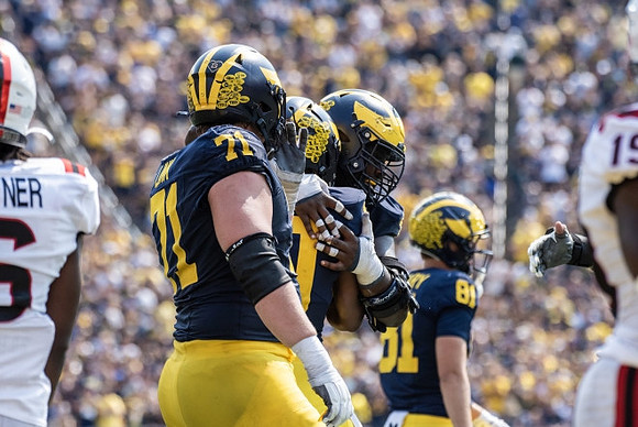 Evan Link (71), Kalel Mullings (20), and Peyton O'Leary (81)