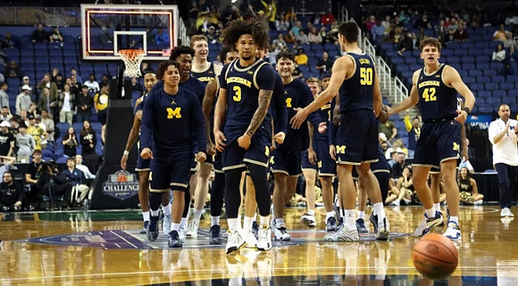 Tre Donaldson (3) and Michigan Team