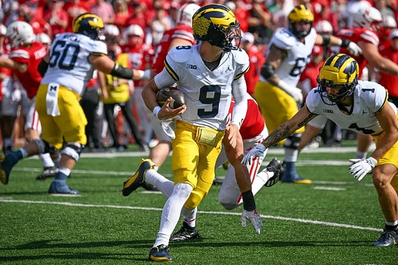 Drake Nugent (60), J.J. McCarthy (9), Zak Zinter (65), and Roman Wilson (1)