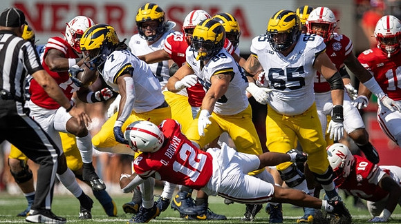 Donovan Edwards (7), AJ Barner (89), and Zak Zinter (65)